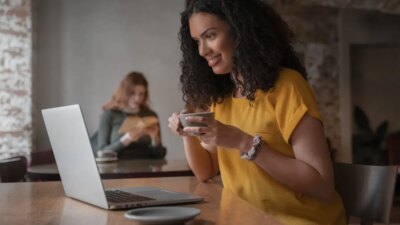 Medium shot women with laptop in coffee shop