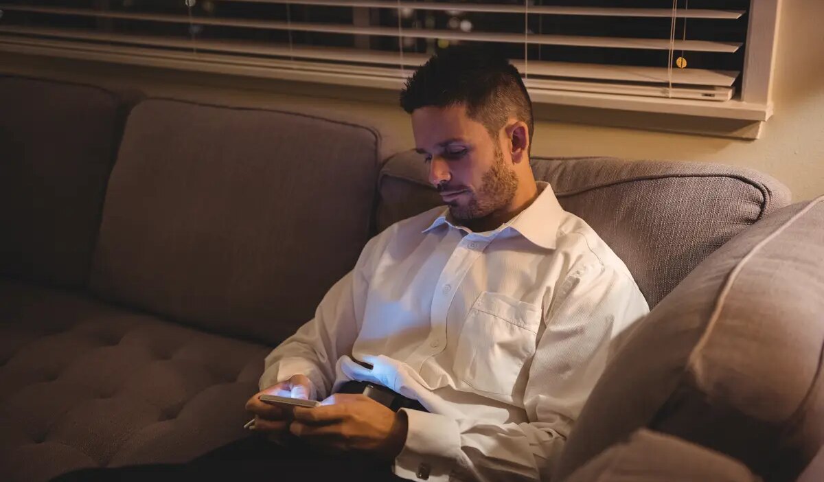 Man using his mobile phone in living room