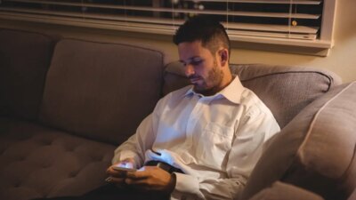 Man using his mobile phone in living room