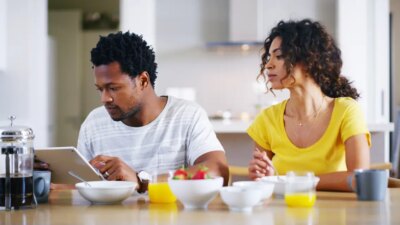 Couple tablet and breakfast in kitchen for social media internet banking and online shopping in morning People tech and browsing in home for ecommerce app nutrition guide and streaming service