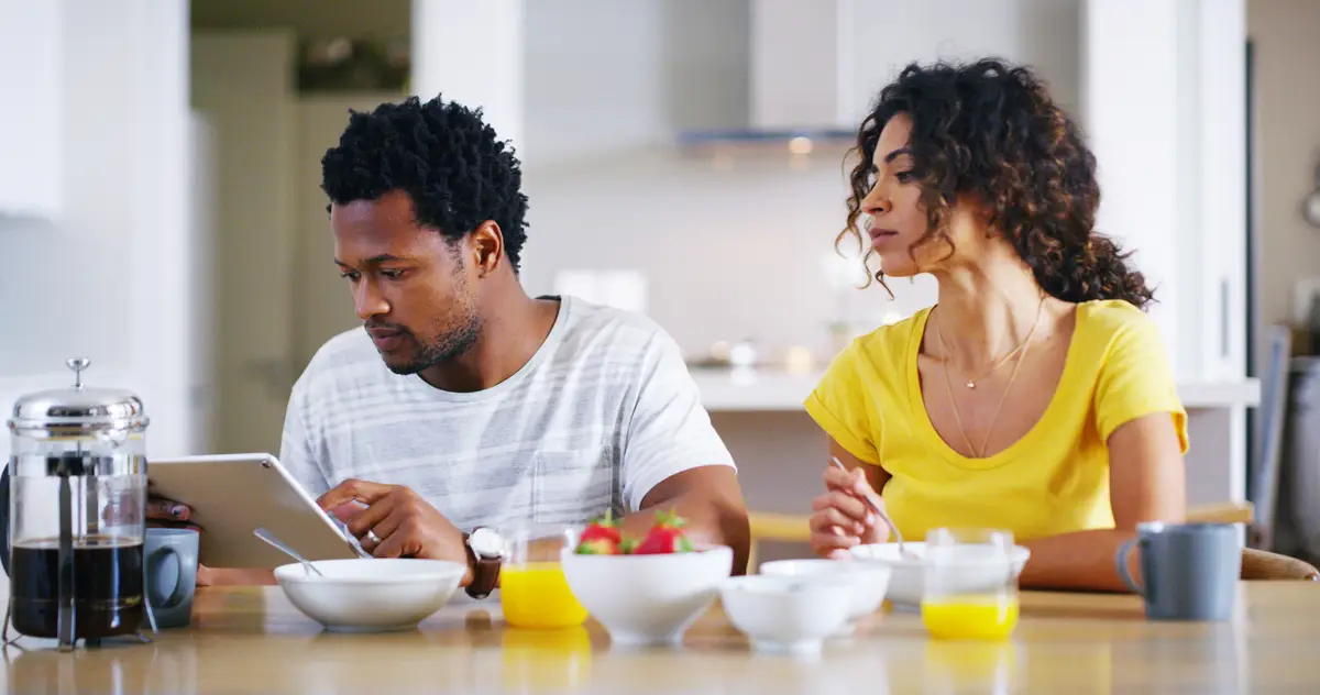 Couple tablet and breakfast in kitchen for social media internet banking and online shopping in morning People tech and browsing in home for ecommerce app nutrition guide and streaming service