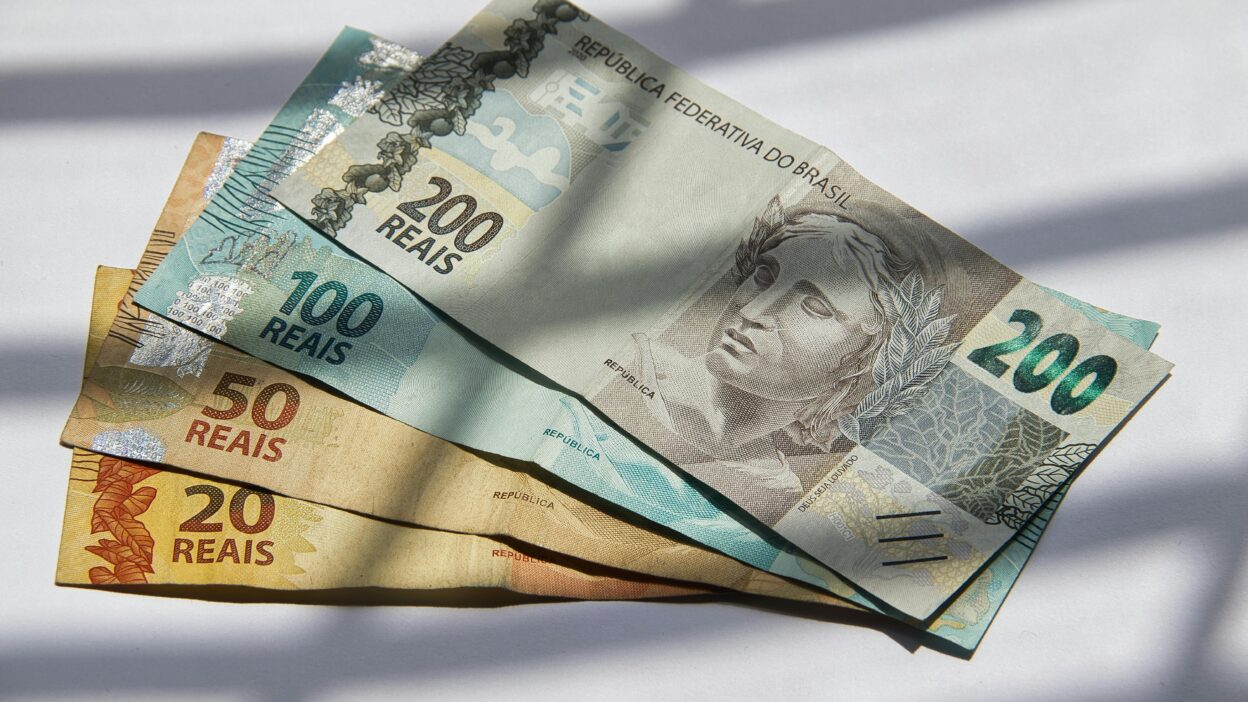 Woman crafting ceramics in home studio with laptop
