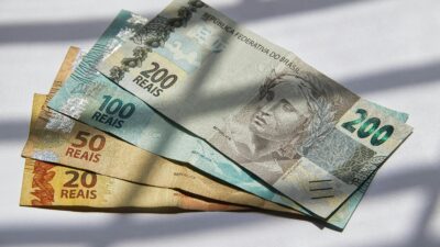 Woman crafting ceramics in home studio with laptop